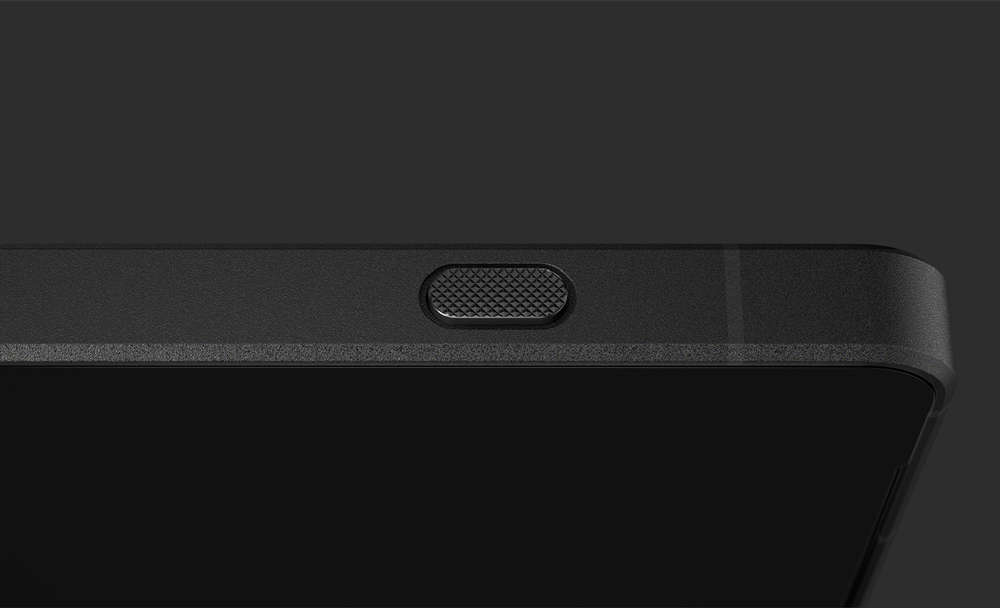 Close up of shutter button on the side of black phone