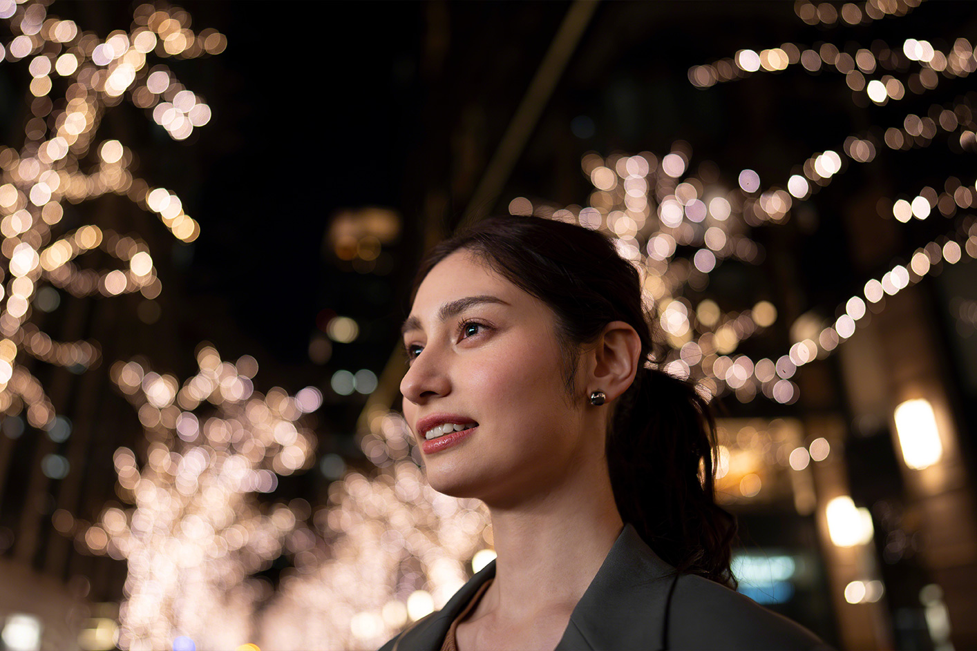 Close up of person smiling against a blurry background